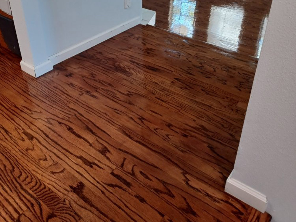 Hardwood flooring in a house with white wall.